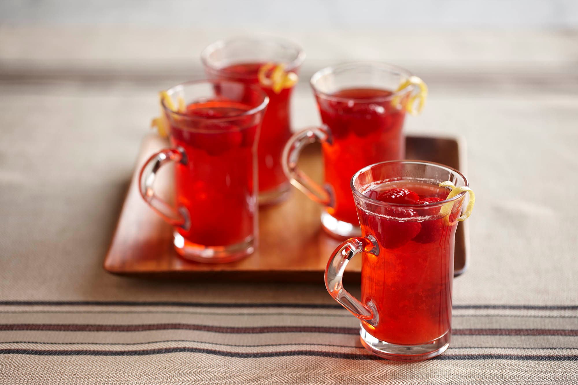 Four glasses of hot spiced raspberry cider